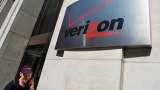 A pedestrian talks on his cell phone while walking past the Verizon Communications Inc. headquarters in New York.